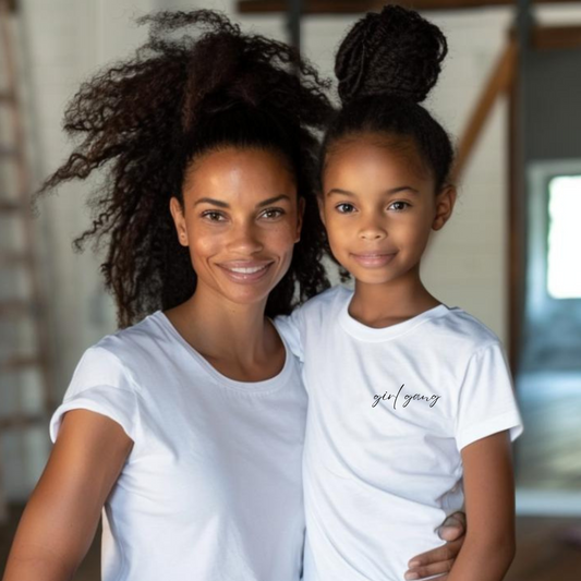 White t-shirt with the words girl gang in a script font on the left pocket area